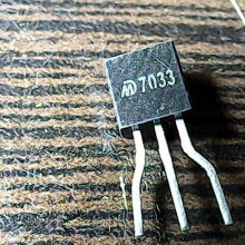 7033